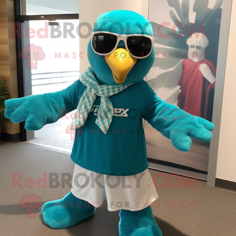 Teal Bald Eagle mascot costume character dressed with a Board Shorts and Scarf clips Teal Bald Eagle mascot costume character dressed with a Board Shorts and Scarf clips