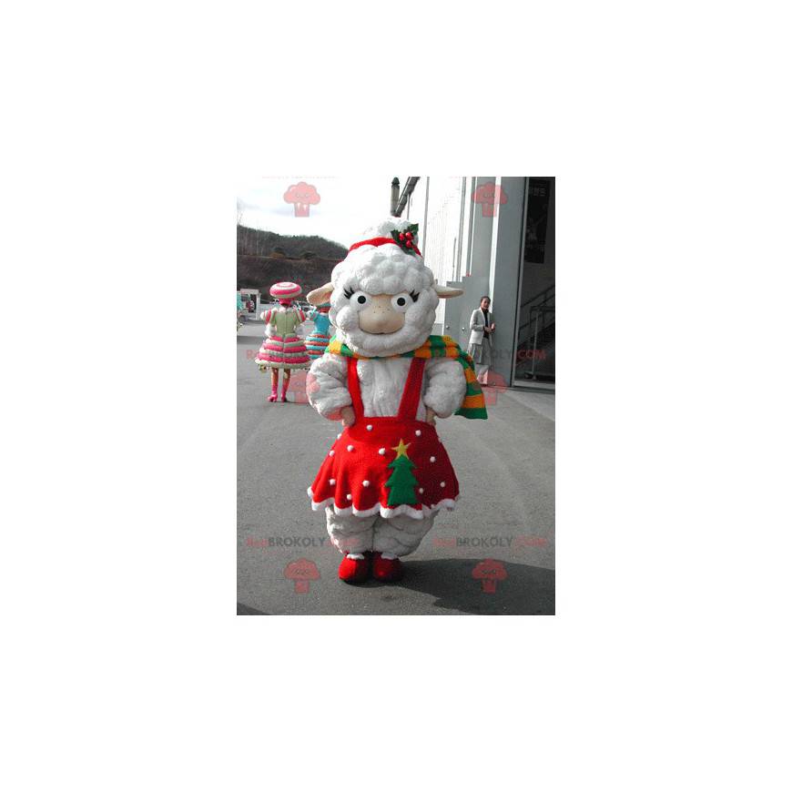 Biała owca maskotka ubrana w czerwoną świąteczną sukienkę -
