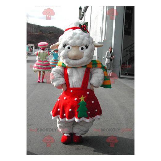 Biała owca maskotka ubrana w czerwoną świąteczną sukienkę -