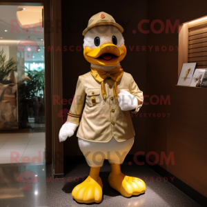 Gold Duck mascot costume character dressed with a Chinos and Brooches