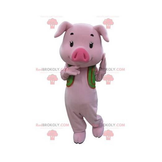 Rosa Schweinemaskottchen mit einer grünen Weste - Redbrokoly.com