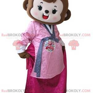 Brązowa małpa maskotka ubrana w różową sukienkę - Redbrokoly.com