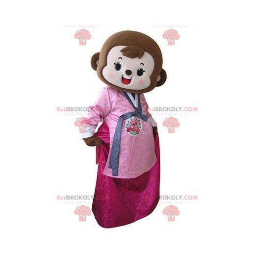 Braunes Affenmaskottchen gekleidet im rosa Kleid -