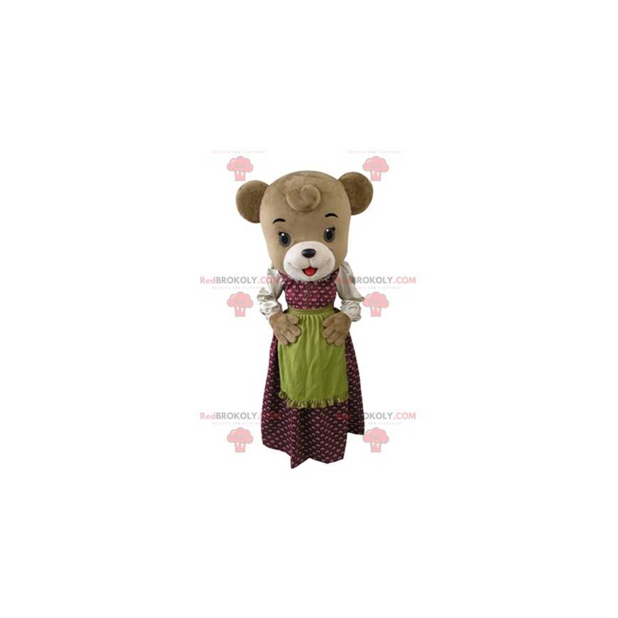 Bruine beer mascotte gekleed in een jurk met een schort -