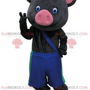Czarno-różowa maskotka świnia z niebieskimi spodniami -