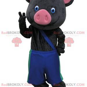 Mascotte di maiale nero e rosa con pantaloni blu -