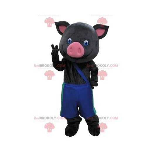 Mascotte de cochon noir et rose avec un pantalon bleu -