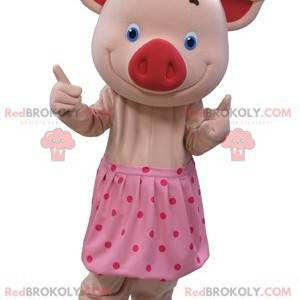 Mascote porco rosa com olhos azuis e saia de bolinhas -