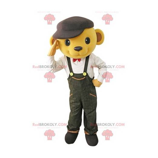 Gele beer mascotte gekleed in overall met een baret -