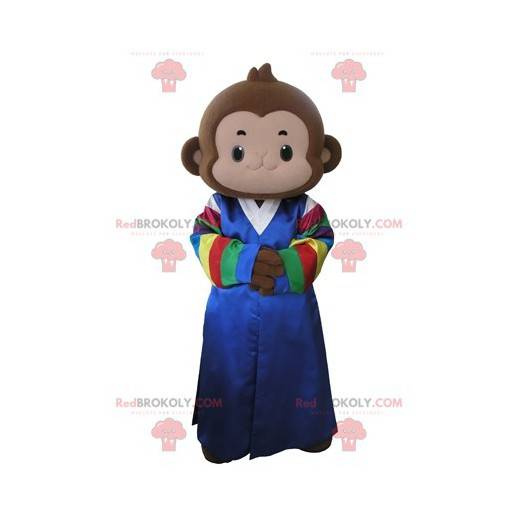 Bruine aap mascotte gekleed in een veelkleurige jurk -