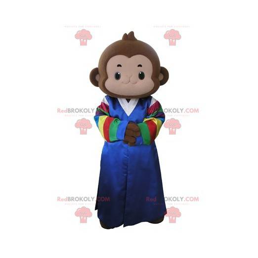 Mascota mono marrón vestida con un vestido multicolor -