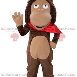 Mascotte de singe marron avec un chapeau d'explorateur -