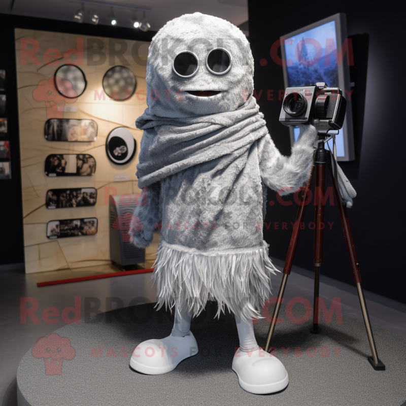 Silver Camera mascot costume character dressed with a Skinny Jeans and Shawl pins