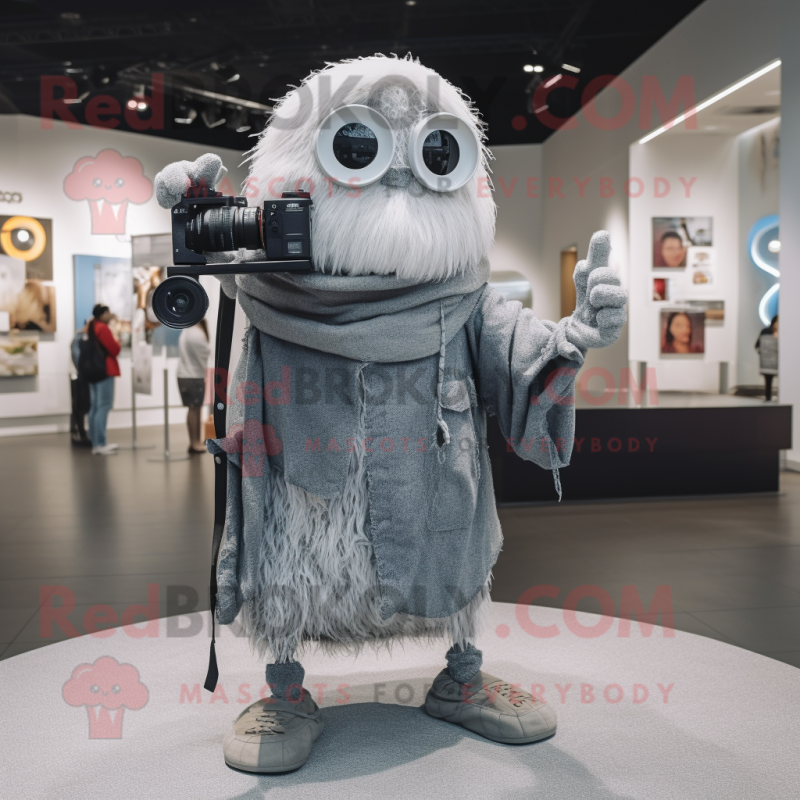 Silver Camera mascot costume character dressed with a Skinny Jeans and Shawl pins Silver Camera mascot costume character dressed with a Skinny Jeans and Shawl pins