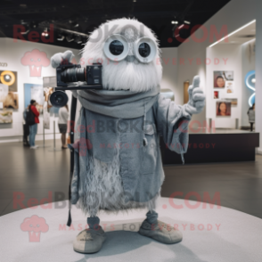 Silver Camera mascot costume character dressed with a Skinny Jeans and Shawl pins