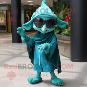 Teal Elf mascot costume character dressed with a Cover-up and Sunglasses