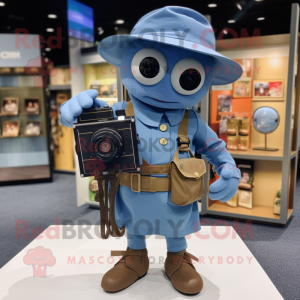 Blue Camera mascot costume character dressed with a Cargo Shorts and Hat pins