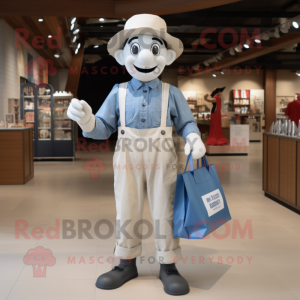 Cream Mime mascot costume character dressed with a Chambray Shirt and Tote bags