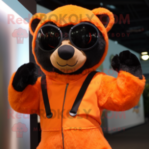 Orange Spectacled Bear mascot costume character dressed with a Jumpsuit and Headbands