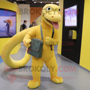 Yellow Titanoboa mascot costume character dressed with a Suit and Clutch bags