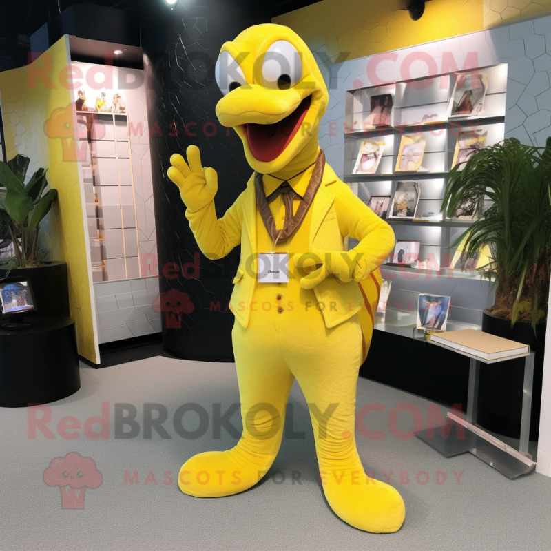 Yellow Titanoboa mascot costume character dressed with a Suit and Clutch bags Yellow Titanoboa mascot costume character dressed with a Suit and Clutch bags
