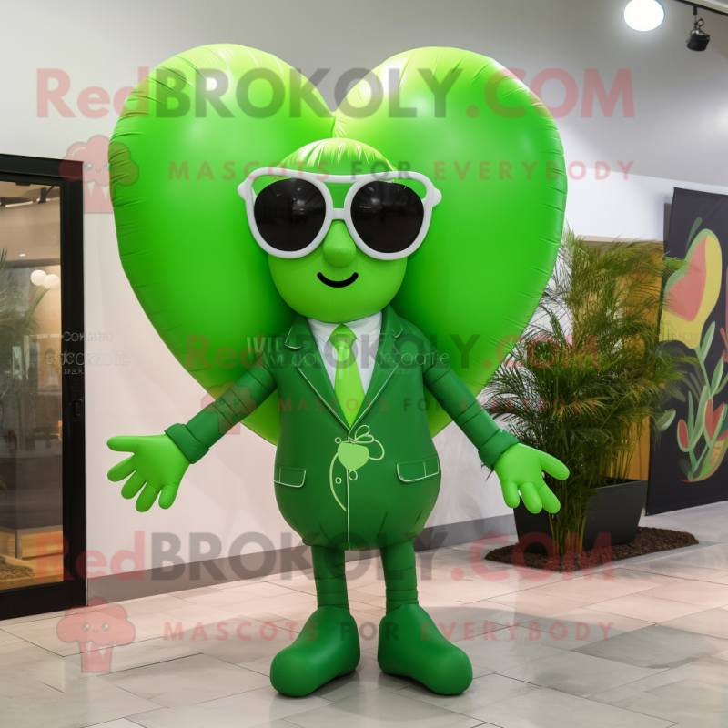 Green Heart Shaped Balloons mascot costume character dressed with a Coat and Sunglasses Green Heart Shaped Balloons mascot costume character dressed with a Coat and Sunglasses