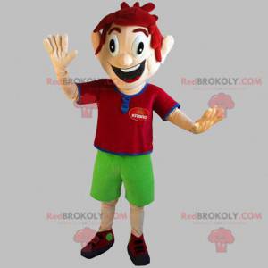 Very smiling red-haired boy mascot with green shorts -