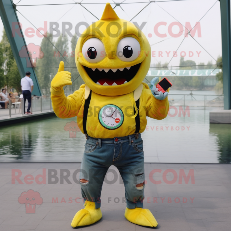 Yellow Piranha mascot costume character dressed with a Jeans and Smartwatches