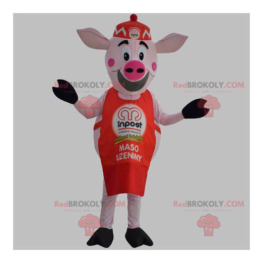 Mascota de cerdo rosa con delantal rojo y gorra. -