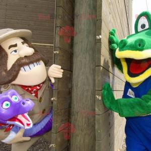 2 mascots a green crocodile and an explorer holding a snake -