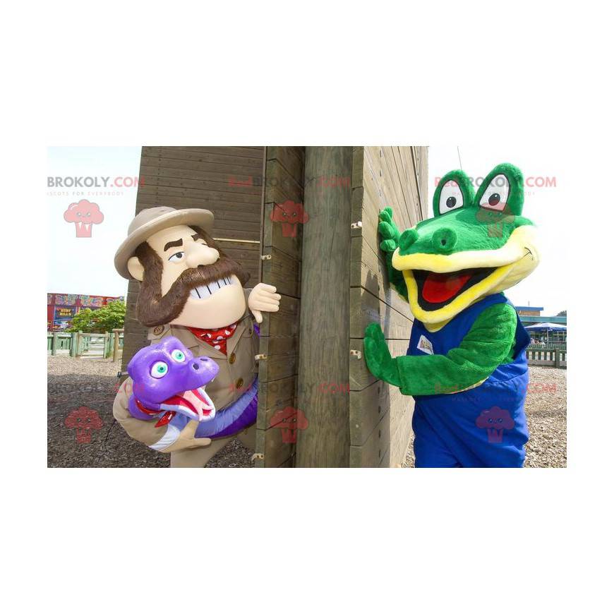 2 mascots a green crocodile and an explorer holding a snake -