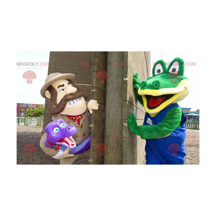 2 maskotar en grön krokodil och en utforskare som håller en orm