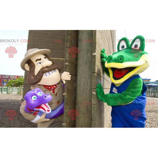 2 mascots a green crocodile and an explorer holding a snake -