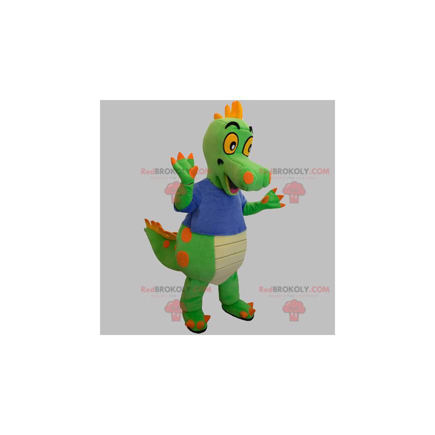 Groen en oranje dinosaurusmascotte met een blauw t-shirt -