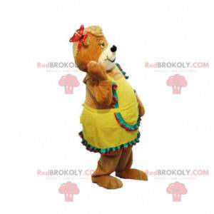 Mascota de peluche marrón con un vestido amarillo -