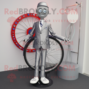 Silver Unicyclist mascot costume character dressed with a Suit Jacket and Shoe clips