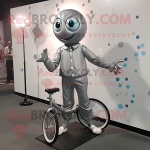 Silver Unicyclist mascot costume character dressed with a Suit Jacket and Shoe clips