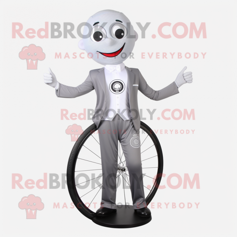 Silver Unicyclist mascot costume character dressed with a Suit Jacket and Shoe clips