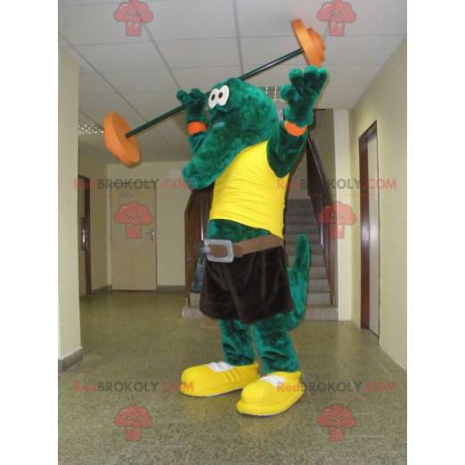 Mascota de cocodrilo verde con una camiseta amarilla -