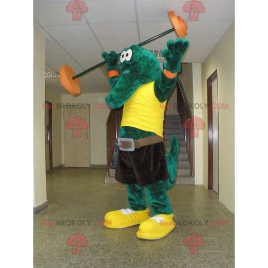 Mascote crocodilo verde com uma camiseta amarela -