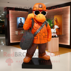 Orange Sniper mascot costume character dressed with a Leather Jacket and Tote bags