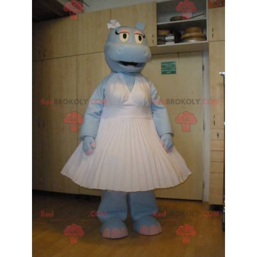 Blauw nijlpaard mascotte draagt ​​een witte jurk -