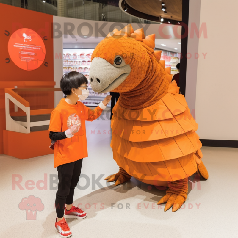 Orange Pangolin mascot costume character dressed with a Long Sleeve Tee and Watches