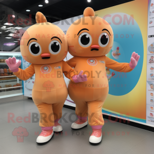 Peach Pair Of Ice Skates mascot costume character dressed with a Jumpsuit and Wraps