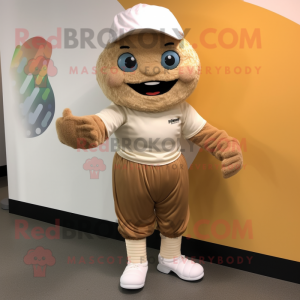 Tan Cupcake mascot costume character dressed with a Joggers and Caps