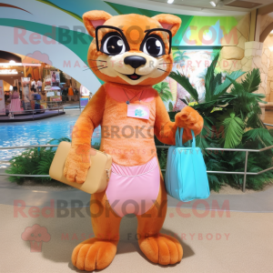 Peach Jaguarundi mascot costume character dressed with a Swimwear and Handbags