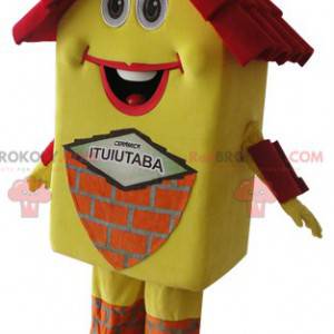 Mascote da casa amarela e vermelha muito sorridente -