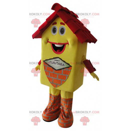Bardzo uśmiechnięta żółta i czerwona maskotka domu -