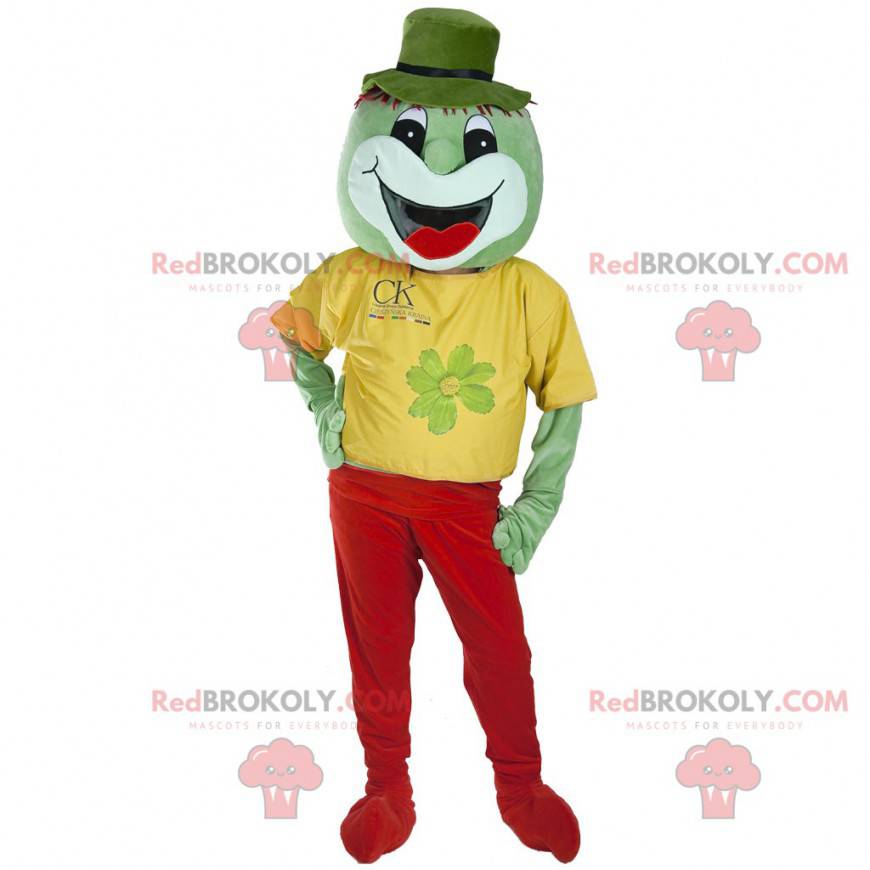 Smiling green creature mascot dressed in red and yellow -