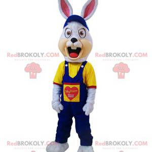 Angry white rabbit mascot dressed in blue overalls -